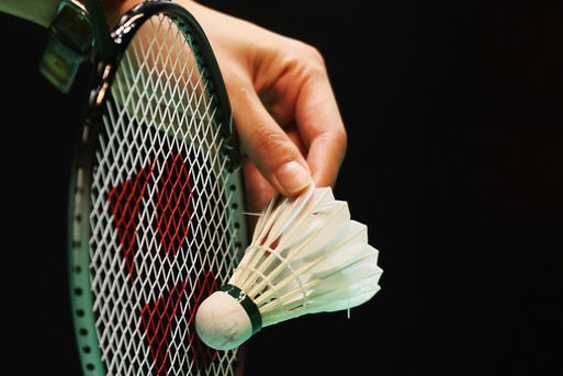 A detailed view of a badminton racquet and shuttlecock