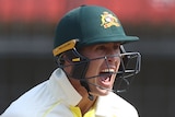 An Australian male Test player screams out as he celebrates defeating India.