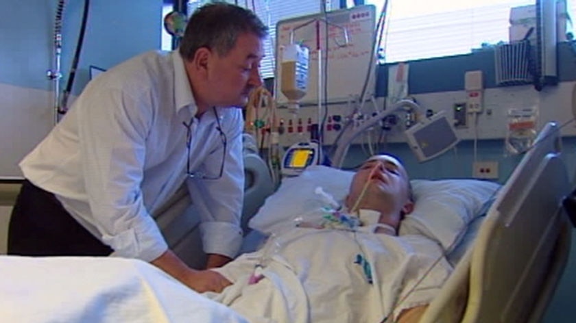 David Keohane, pictured with his father in a Sydney hospital, has been in a coma since he was bashed