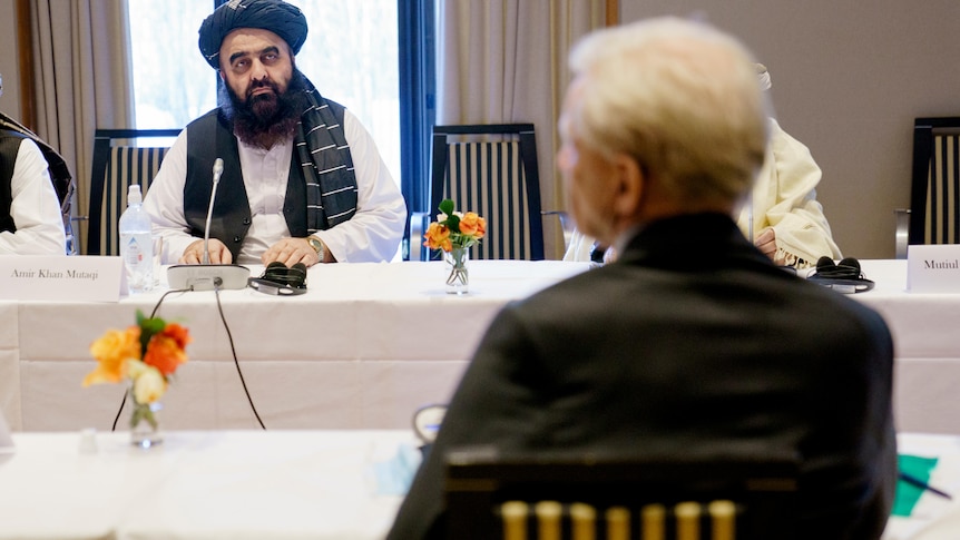 A Taliban representative sits opposite the head of the Norwegian Refugee Council