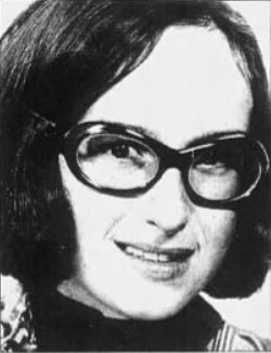 A black and white photo of a young woman wearing glasses 