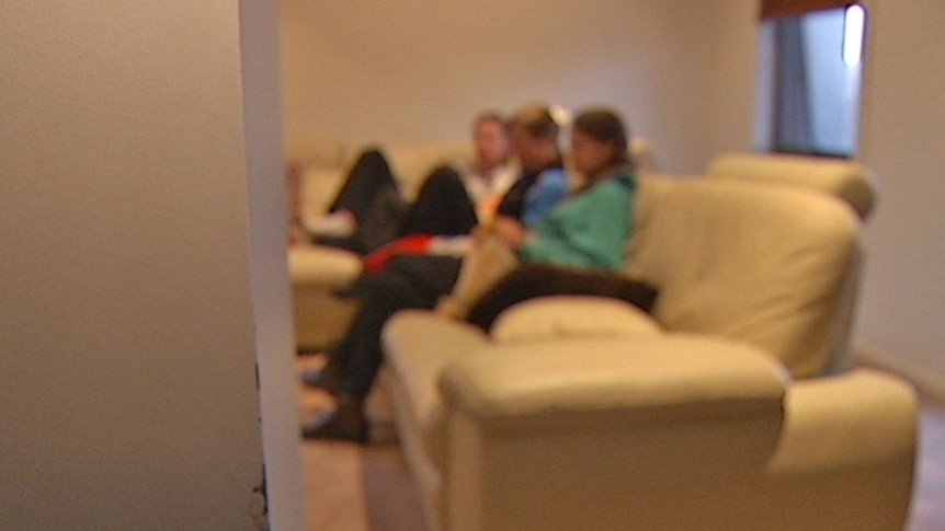 Video still: Blurred image of young people sitting on a lounge chair  - generic