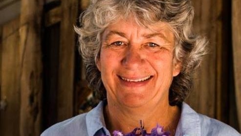 Suspected murder victim Cynda Miles from Margaret River holds a bunch of purple flowers.