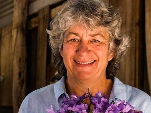 Suspected murder victim Cynda Miles from Margaret River holds a bunch of purple flowers.