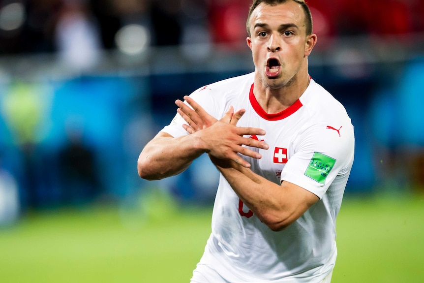 Xherdan Shaqiri makes a symbol with his hands after scoring goal