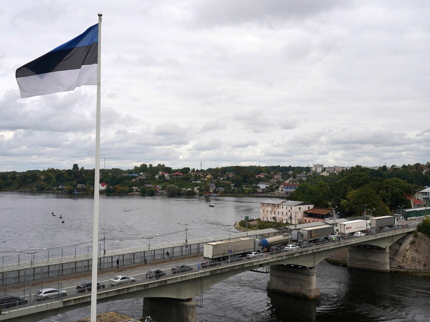 An Estonian flag flies above the bridge which is the border crossing from 