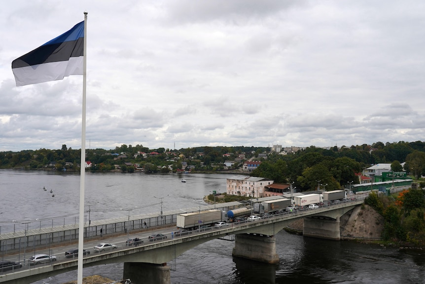 An Estonian flag flies near the bridge over Narva river.