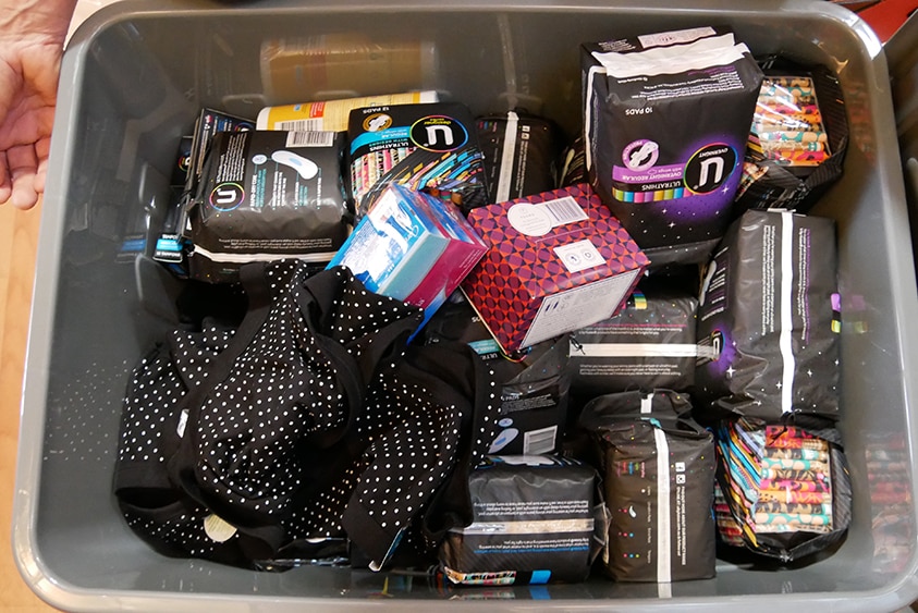 Sanitary items and underpants in a plastic box for girls to use