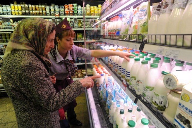Two women look at milk in Russian supermarket