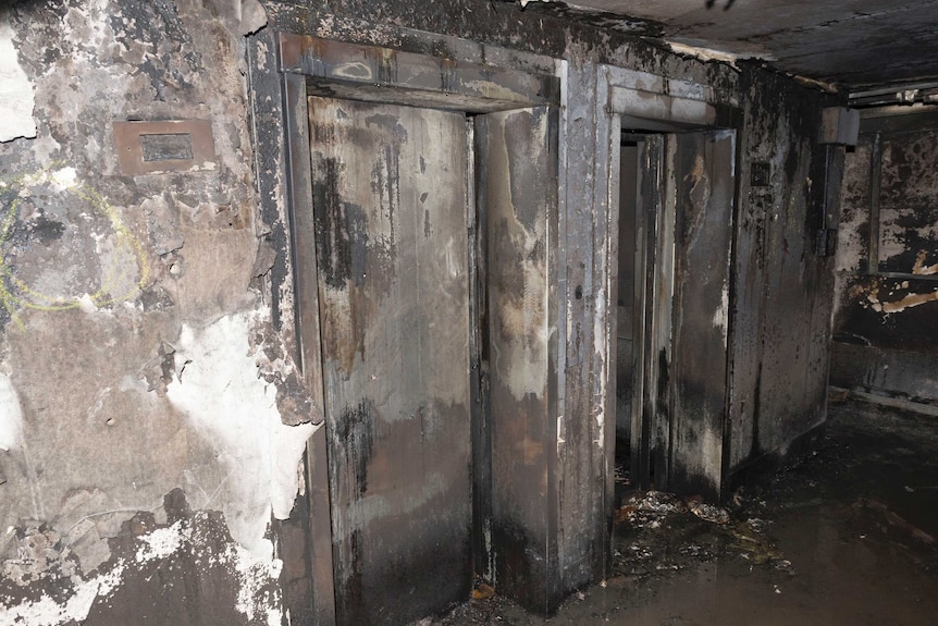 A photo shows the elevators in Grenfell Towers completely burned and covered in ash.