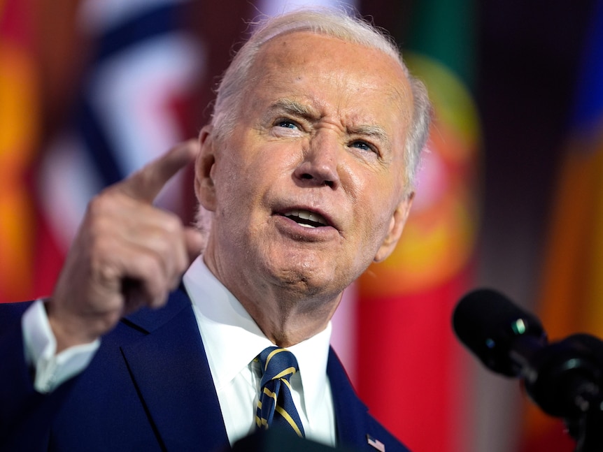 A close up of Joe Biden speaking passionately and pointing with his right hand