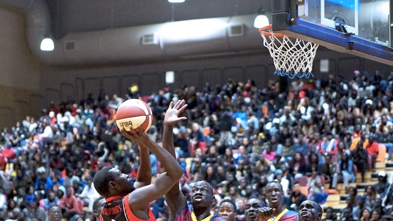 Leaning back to avoid his opponent, a player for the Yarra sets to shoot at the basket