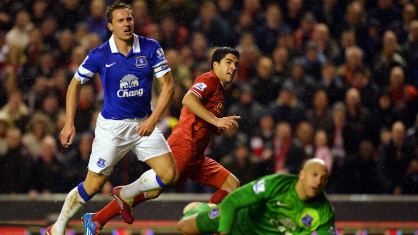 Liverpool's Luis Suarez (C) celebrates as he scores against Everton in the EPL in January 2014.
