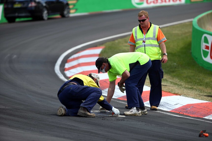 Officials repair turn two at Mount Panorama
