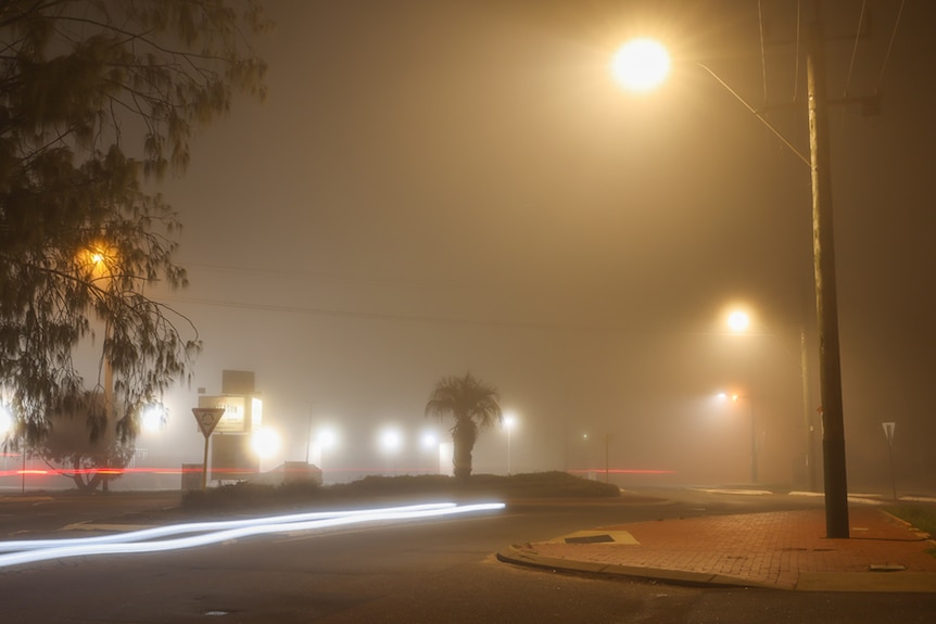 A street covered by fog 