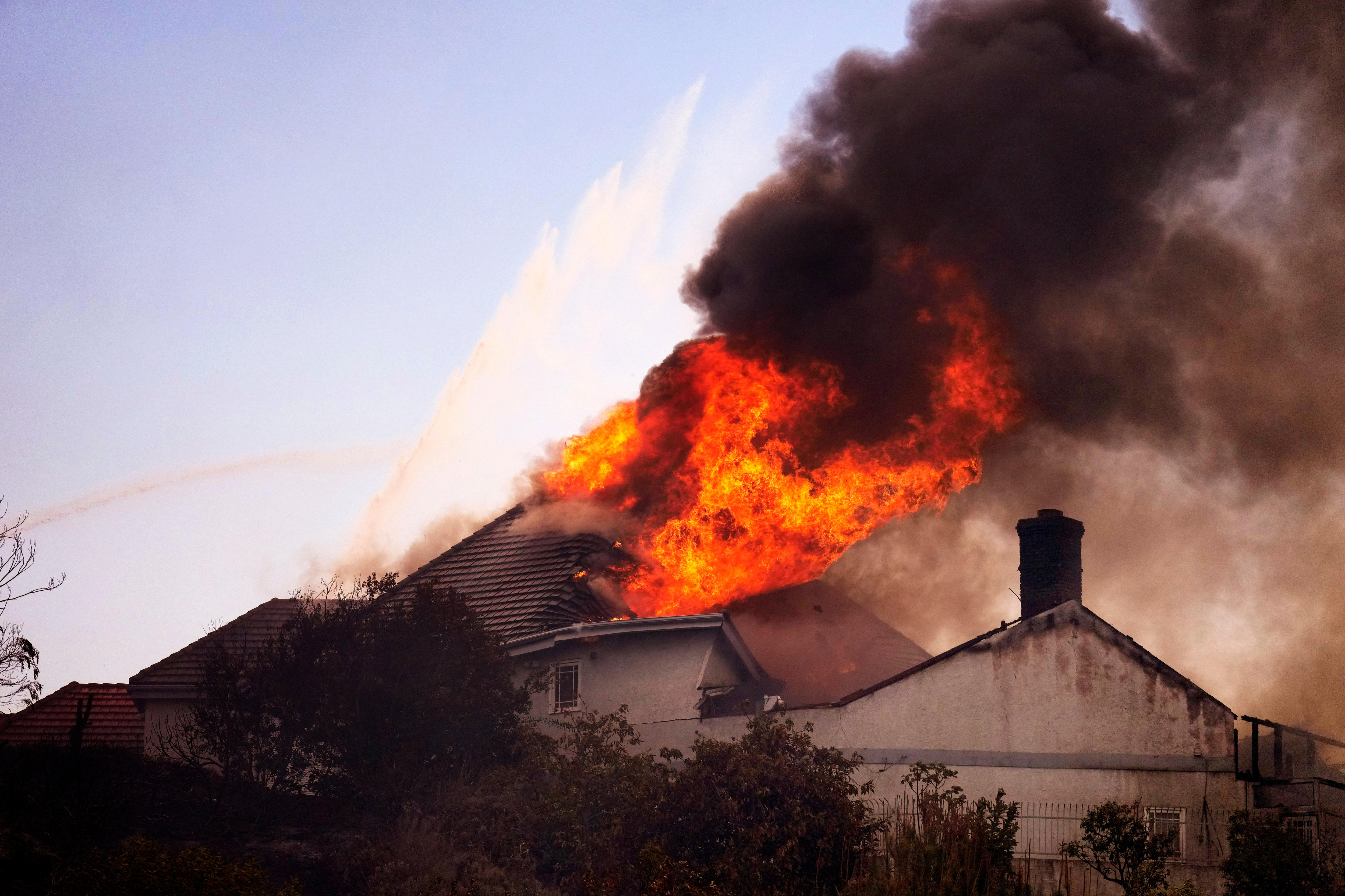 Wildfires rage in Southern California, burn homes