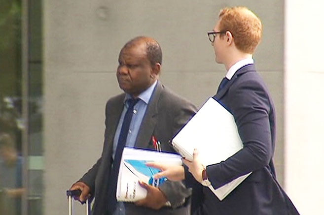 Tony Bakare (left) arrives at court in Brisbane.