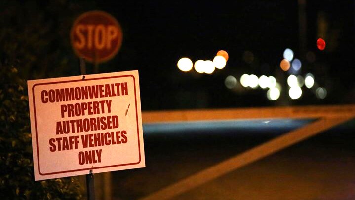 A sign at the entrance to Christmas Island's detention centre at night saying only authorised staff vehicles are allowed.