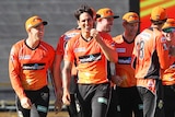 Mitchell Johnson (C) celebrates dismissing Rob Quiney with the first ball of the match