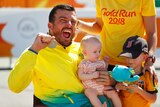 Australia's Kurt Fearnley reacts to his Commonwealth Games T54 marathon gold medal with his family.
