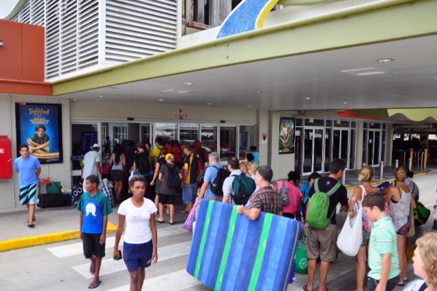 People enter the Earlville evacuation centre in Cairns ahead of Cyclone Yasi