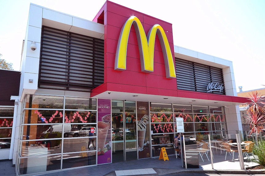 A McDonald's fast food restaurant with the golden arches sign above the doors