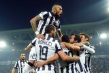 Juventus celebrates Carlos Tevez's goal against Real Madrid