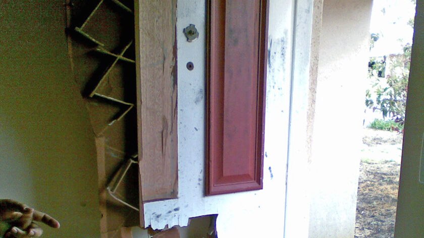 The front door was smashed in during a home invasion in Perth's northern suburbs.