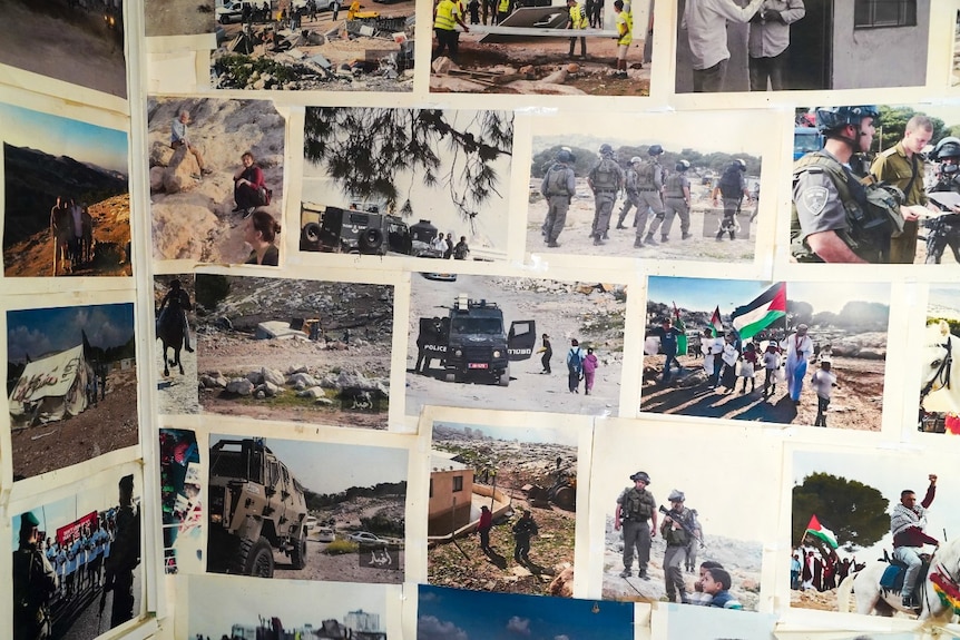 A wall with several photos on it, mainly of civilians and soldiers