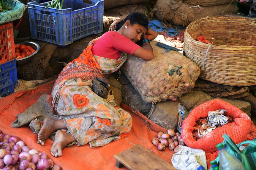 An Indian vendor rests during a heatwave