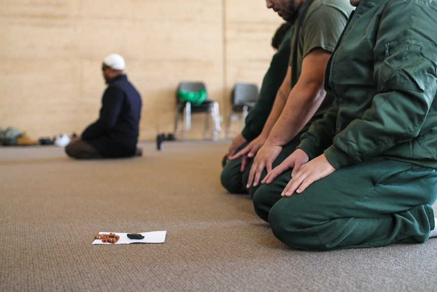 Muslim prisoners kneeling for prayer at the multi-faith centre at Hopkins Correctional Centre.