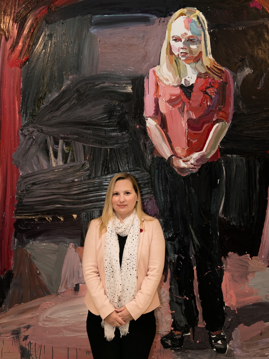 Elvi Wood with her portrait by Ben Quilty at the Australian War Memorial