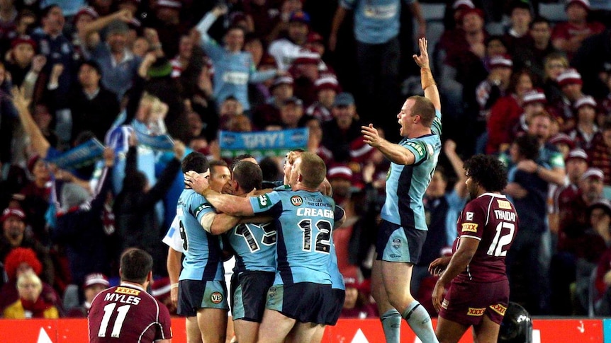 Blue celebrations ... New South Wales goes wild as Anthony Minichiello seals victory.