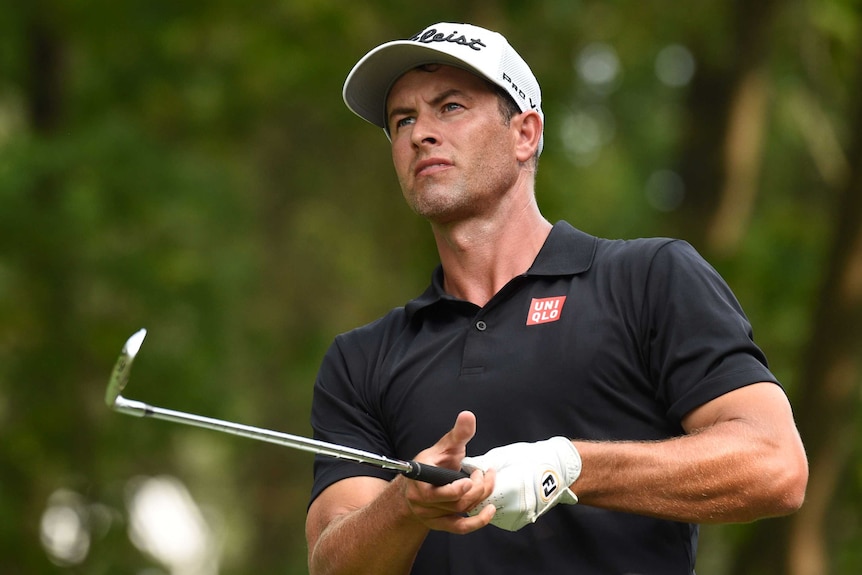 Adam Scott watches his shot.