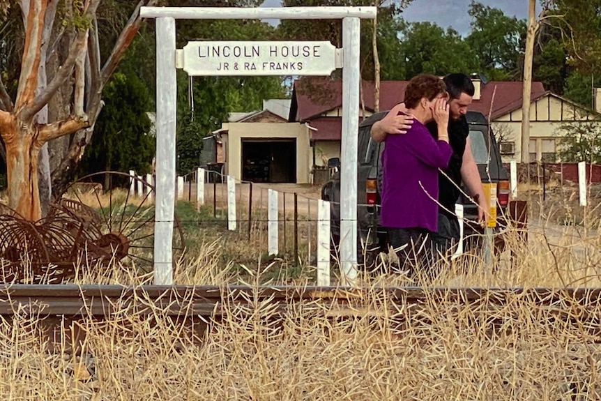 two people near the train tracks