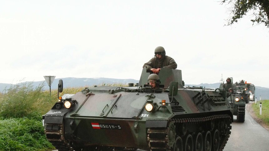 Austrian army APCs approach a crime scene near Melk some 80 km west of Vienna September 17, 2013. A suspected game poacher shot two policemen and a paramedic after they tried to arrest him in woodland, police said on Thursday. (Reuters:Heinz-Peter Bader)