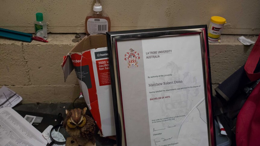 Framed university degree sits among other possessions