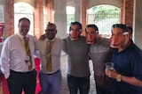 Cricket South Africa officials Clive Eksteen and Altaaf Kazi pose with spectators wearing Sonny Bill Williams masks.