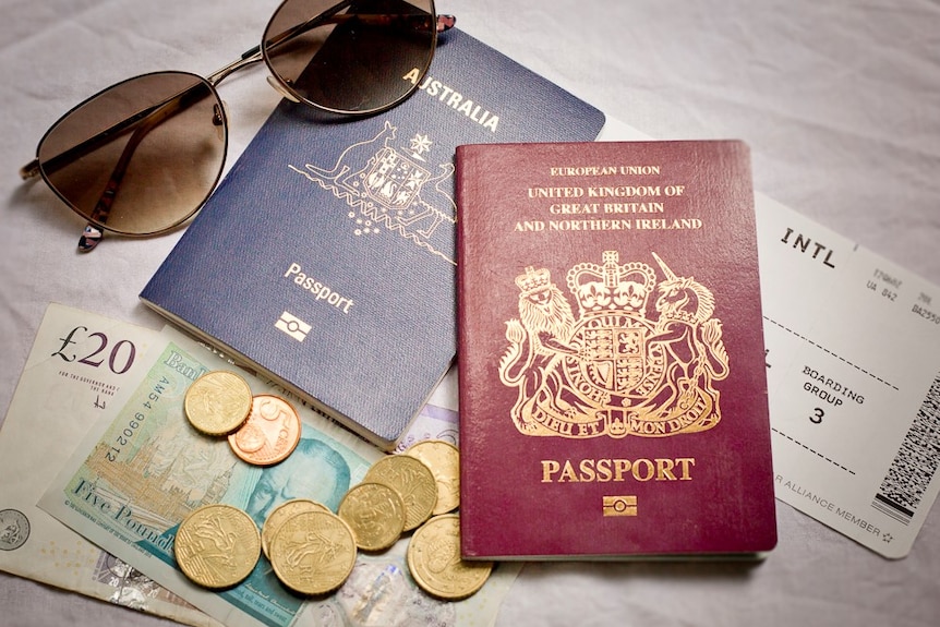 An Australian and UK passport lay on a bench.