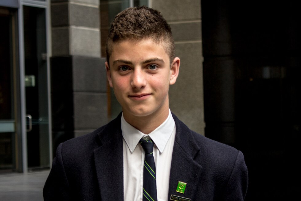 A teenage boy in school uniform