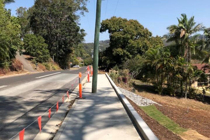 A pole built in the middle of a footpath.