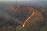 An aerial photo of a fire burning on a hill.