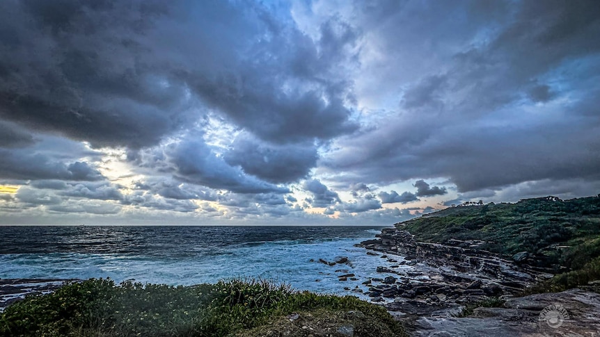 Storms clouds gather and spread along the Sydney coast
