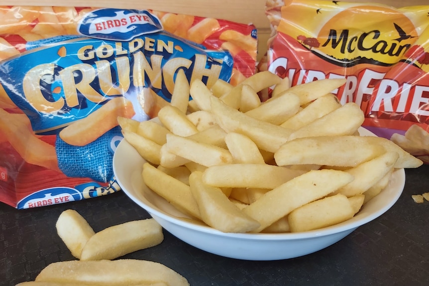 two packets of frozen potato chips sit behind a bowl of chips