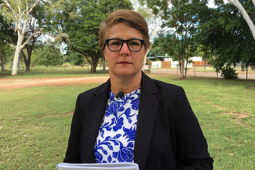 Justice Rachel Pepper holds documents in a park