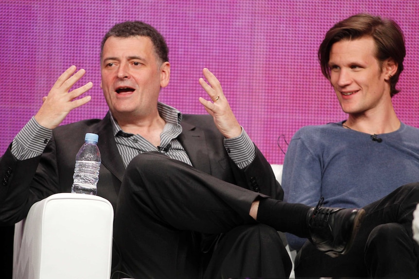 Steven Moffat and Matt Smith sitting together on a couch.