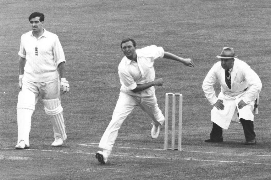 Richie Benaud is watched carefully by the umpire as he bowls in the England v Australia test match in 1961.