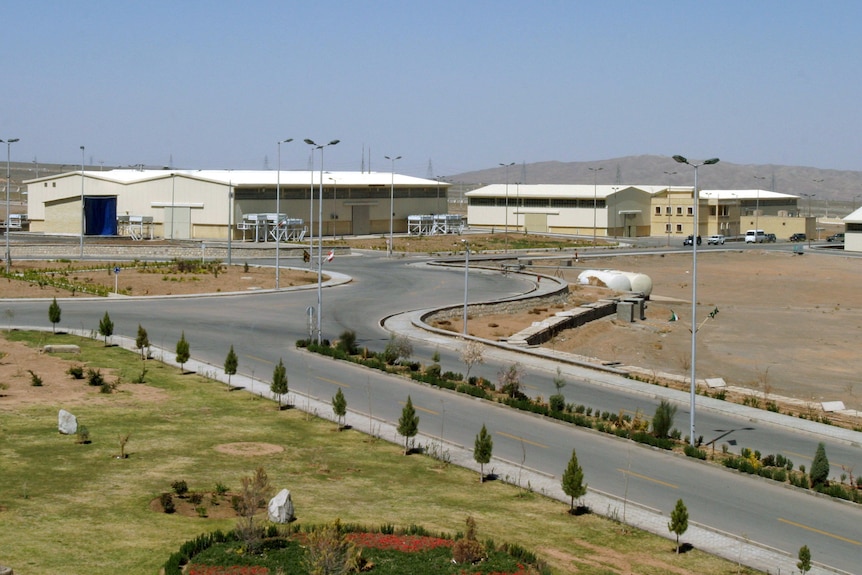 An exterior shot of a series of low buildings and a road.