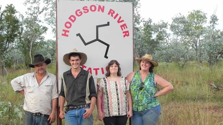 a family standing in front of a station sign
