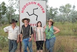 a family standing in front of a station sign